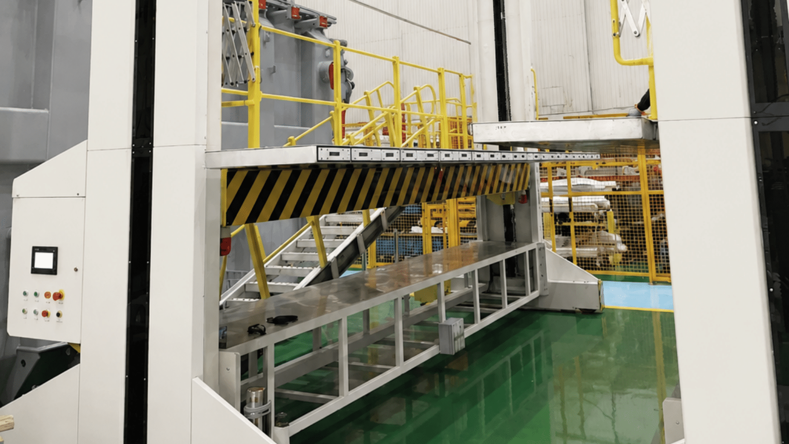 Another angle of the yellow platform deck with striped safety markings and surrounding railings