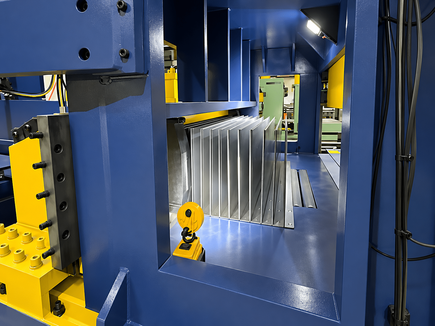 Steel sheet being progressively folded into corrugations inside the forming cavity