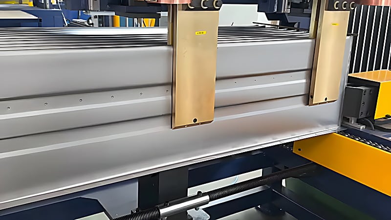 Two copper electrodes pressing onto the stiffener position of a corrugated fin to make a spot weld