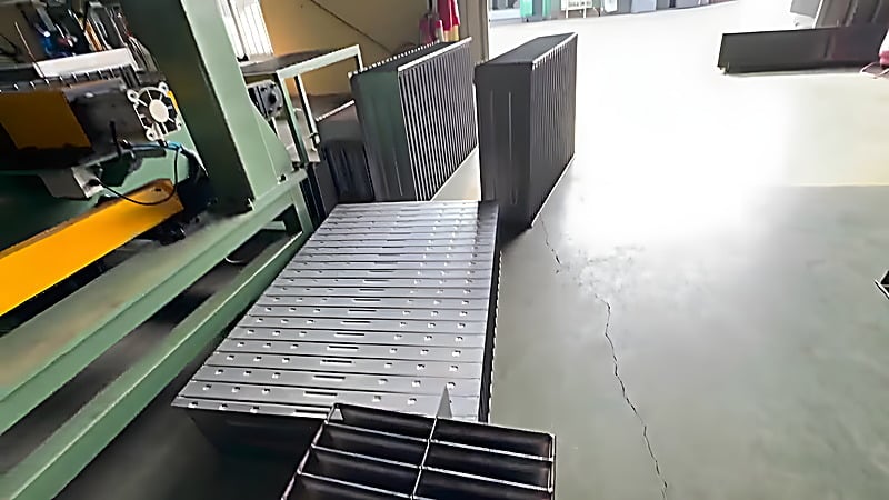 Finished corrugated fins stacked at the end of the production line inside the customer's workshop