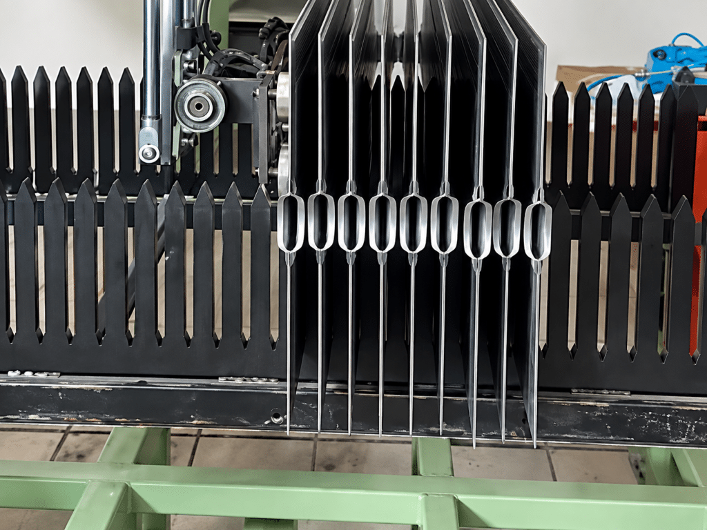 Welded radiator fin assemblies with dense cooling fins waiting at the unloading position